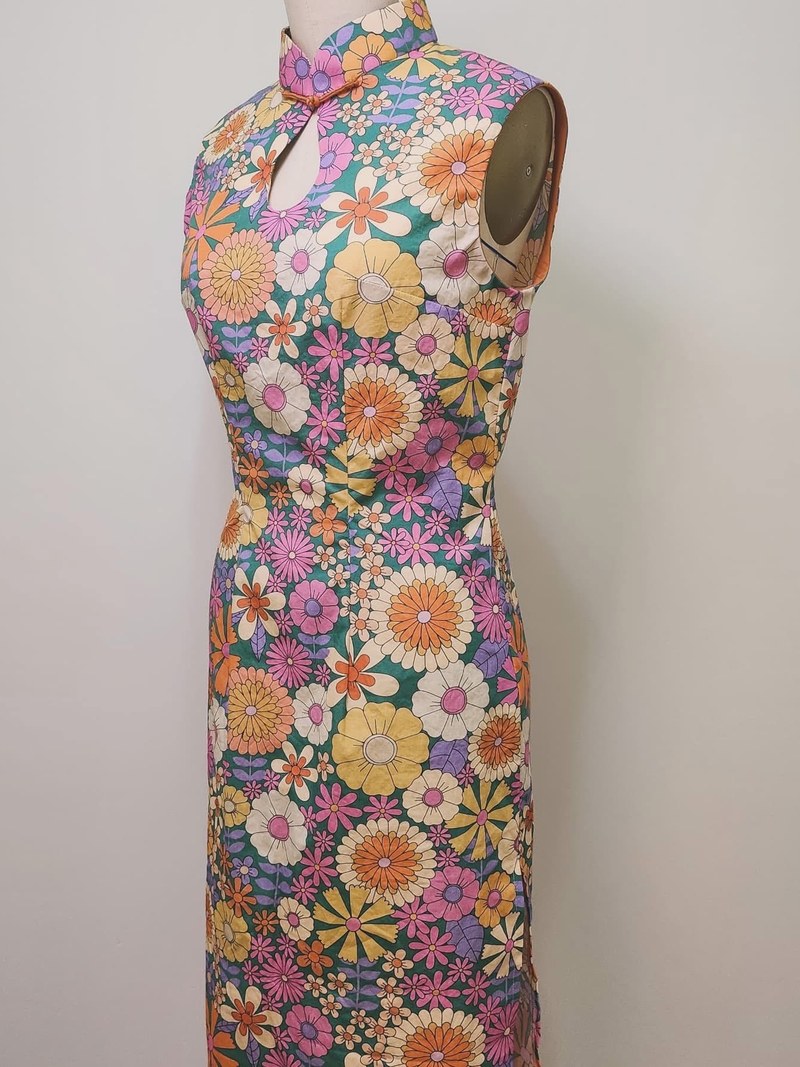 Three-quarter view of a bespoke floral garment, showing the neckline detail
