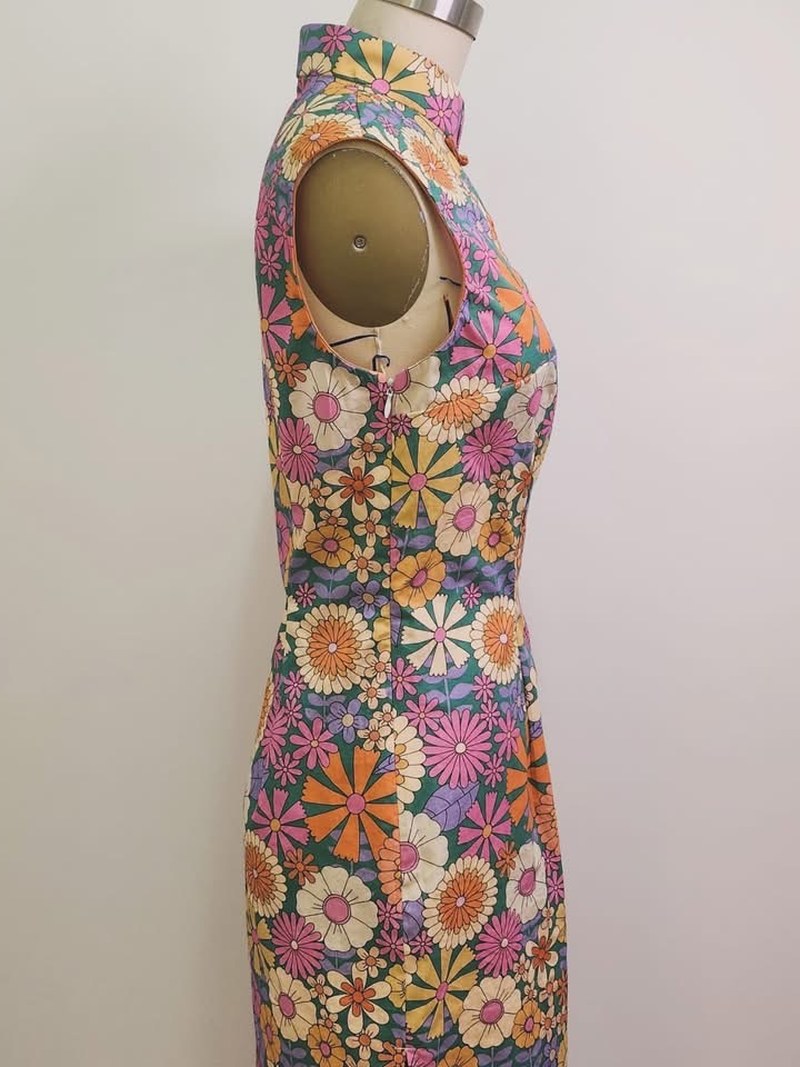 Side profile of a bespoke floral garment, showing neckline through waist and hip shaping