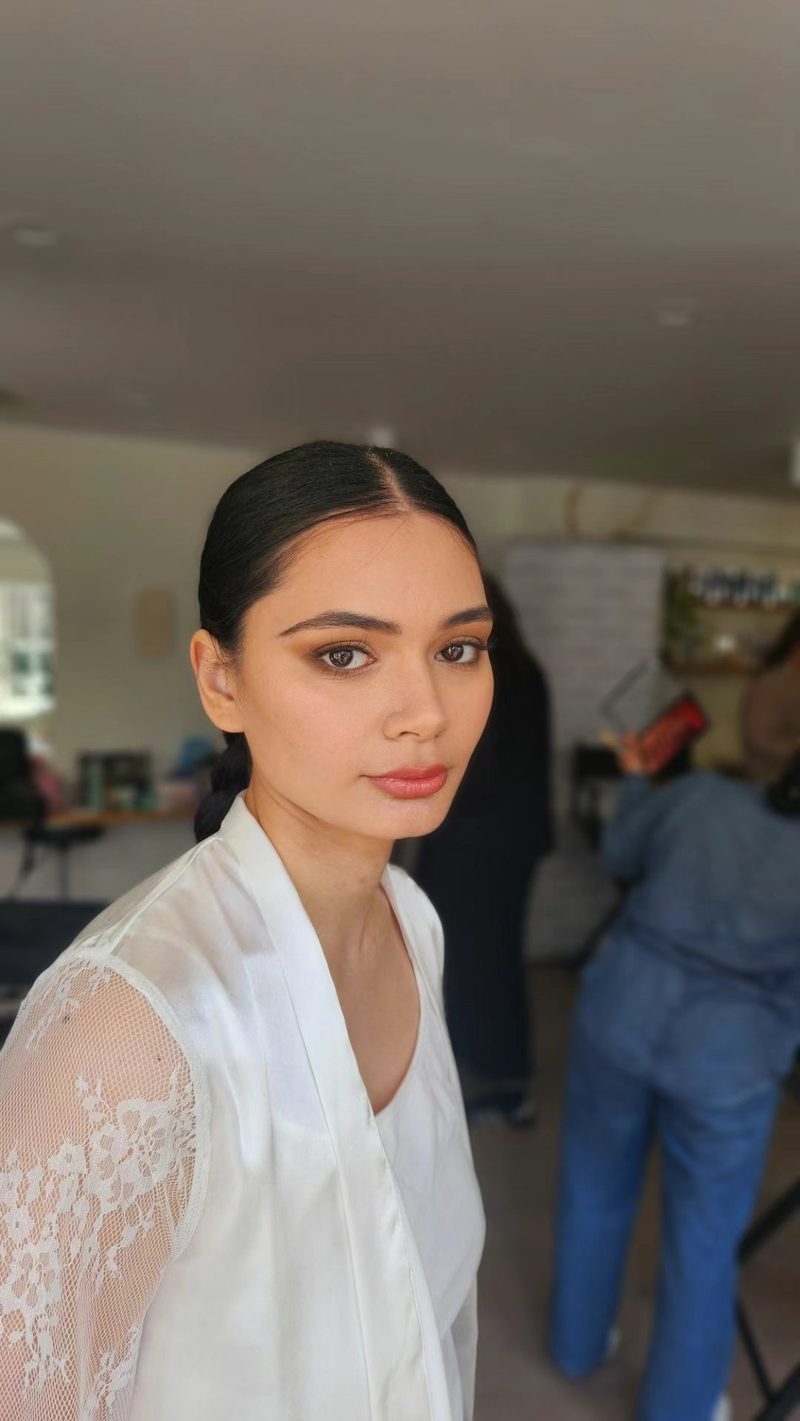 Three-quarter portrait, front-facing, with soft, natural makeup